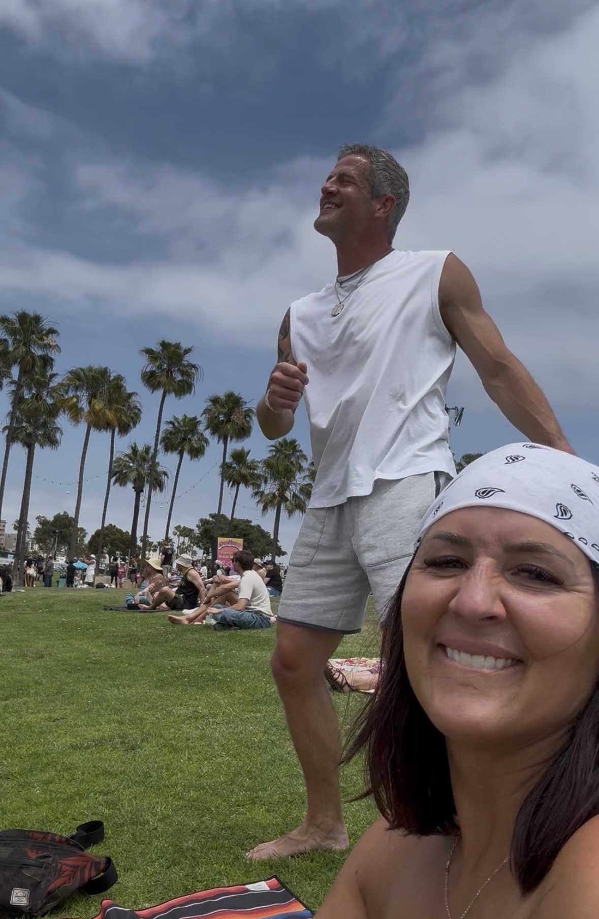 Brandon Burke laughing outdoors alongside his wife Darci