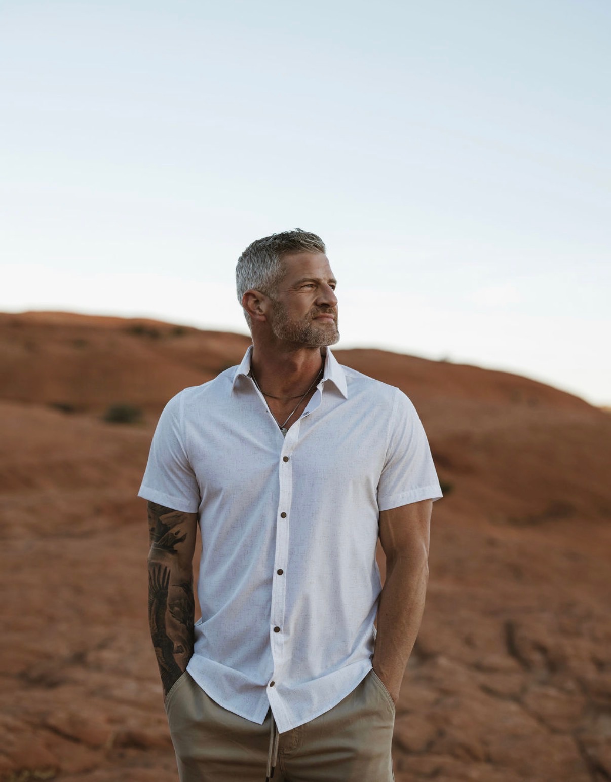 Brandon Burke standing in a desert landscape at golden hour