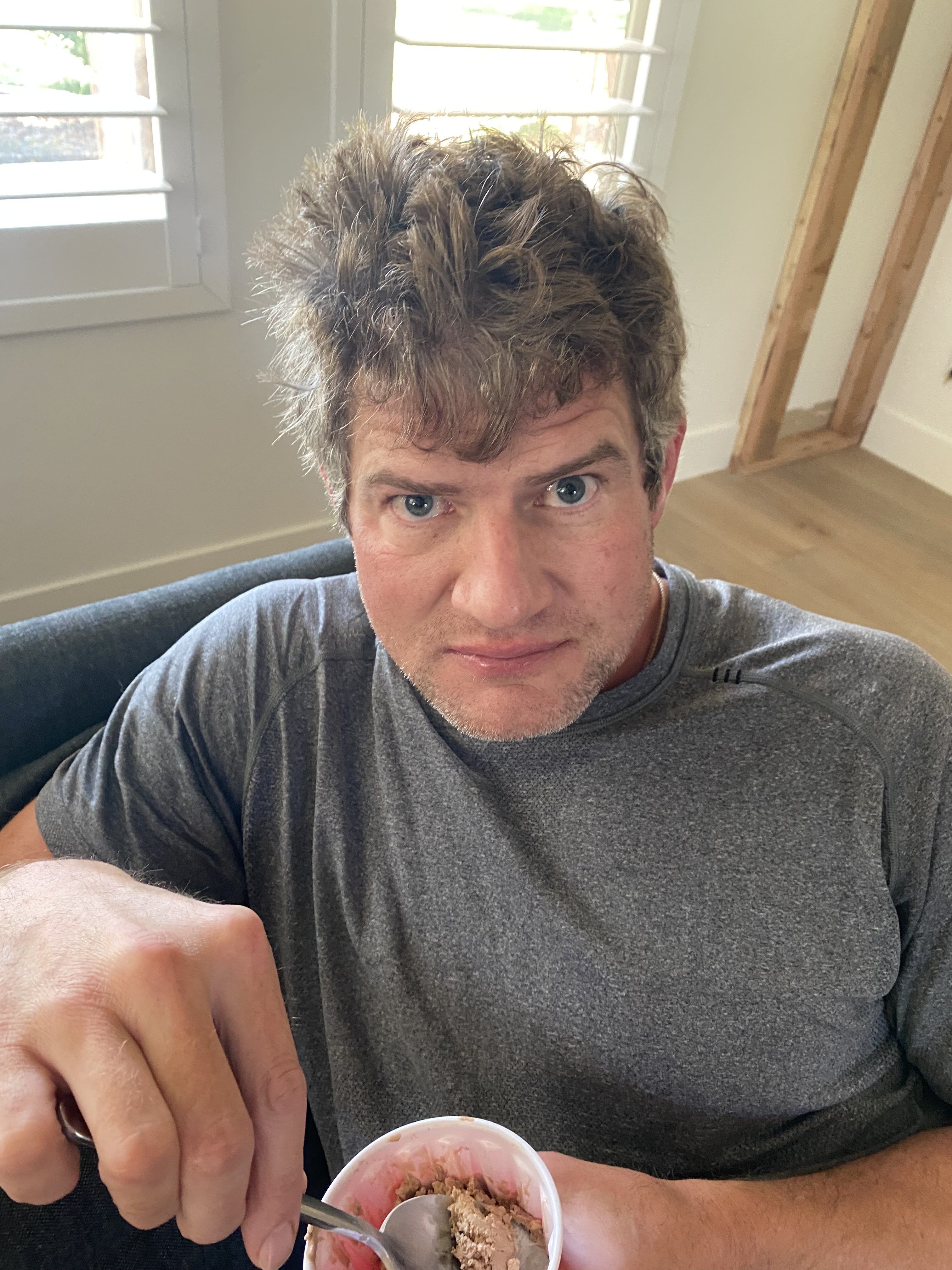 Brandon Burke sitting indoors with a contemplative, vulnerable expression